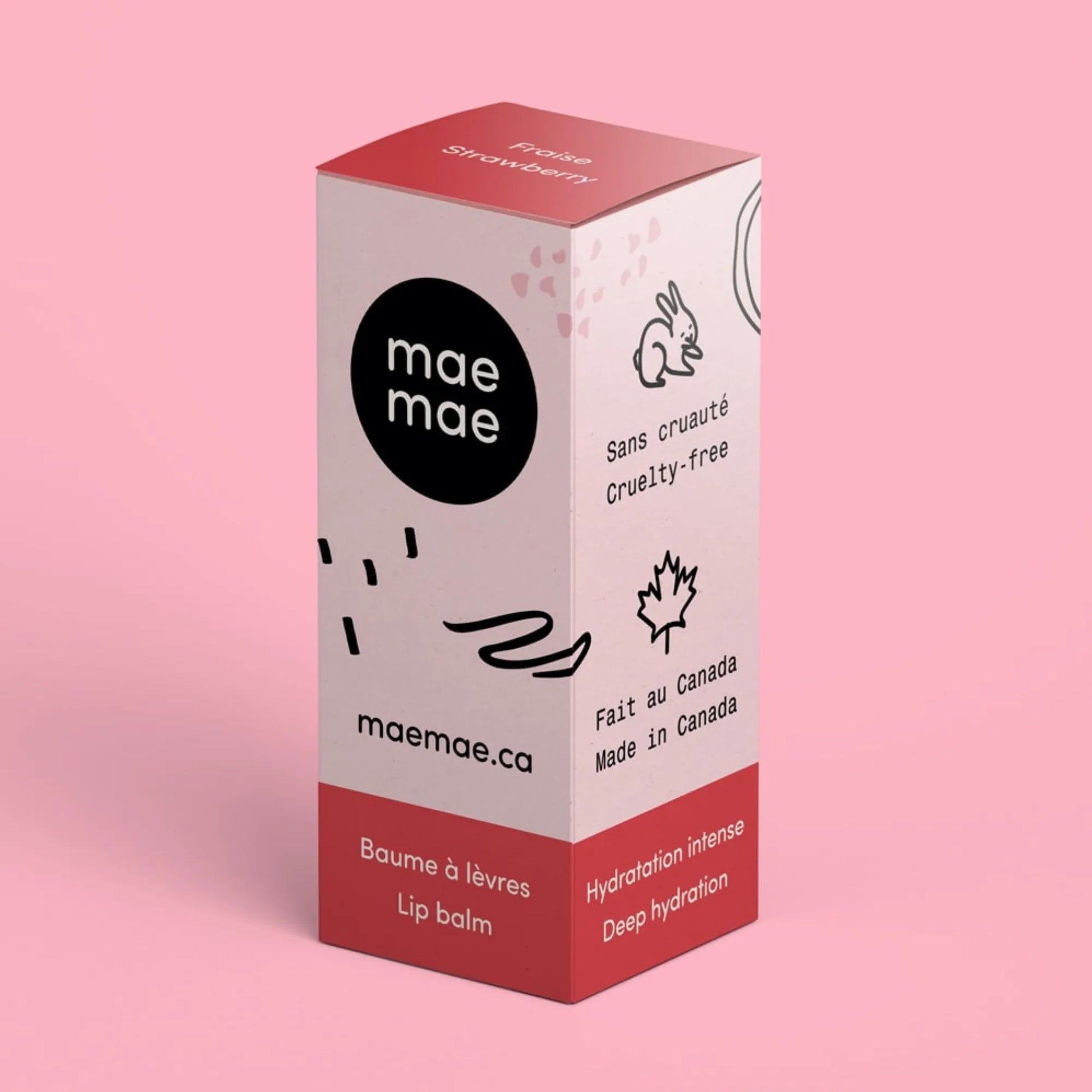 Boîte du baume à lèvres naturel à la fraise mae mae sur fond rose